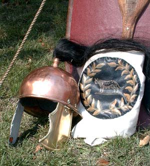 This closeup of the early Republican helmet clearly shows the horsehair plume.  The shield cover with wolf within wreath design is to the right. Part of the early Republican era scutum can be seen behind the helmet and shield cover.